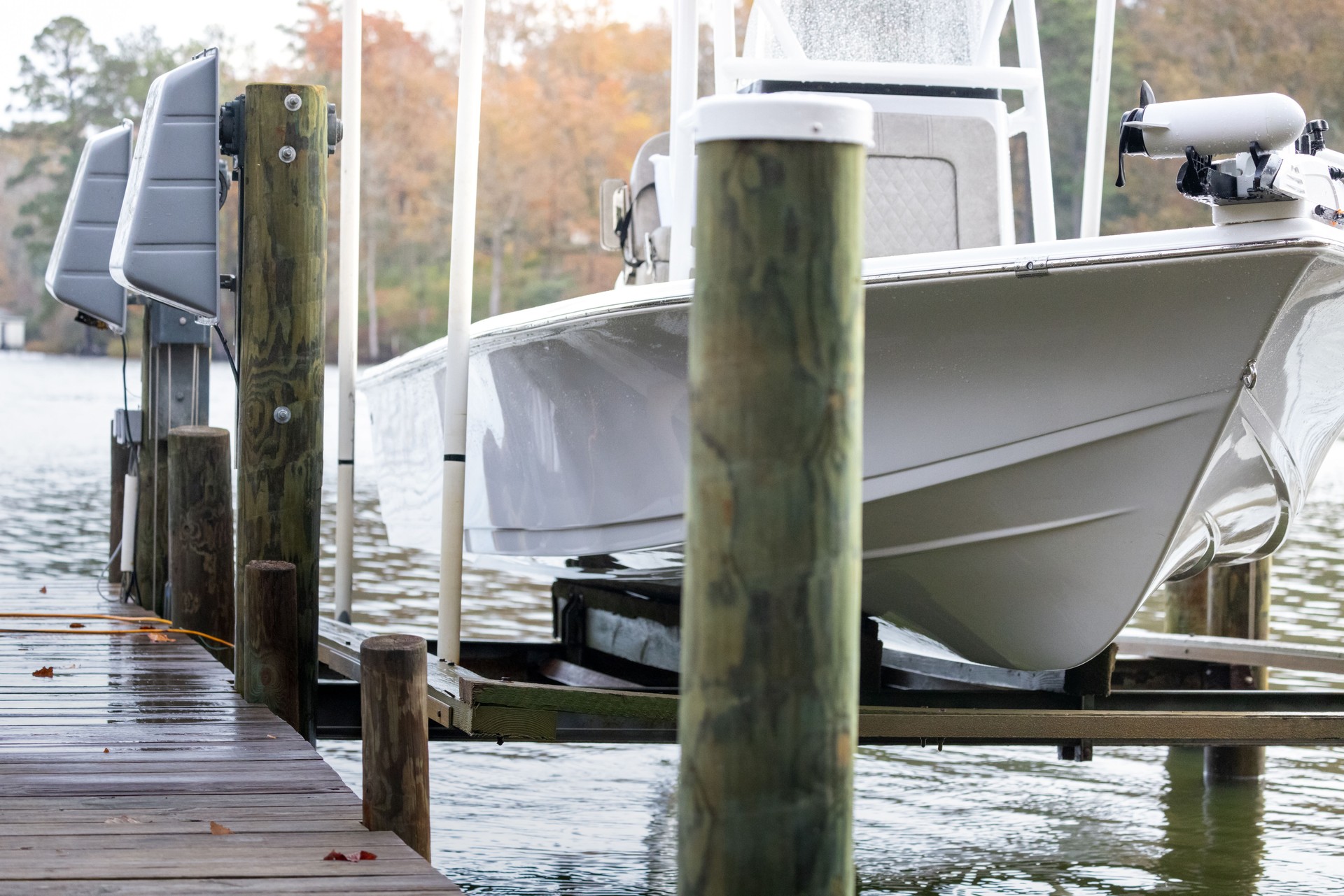 Bay Boat on raised boat lift attached to residential dock